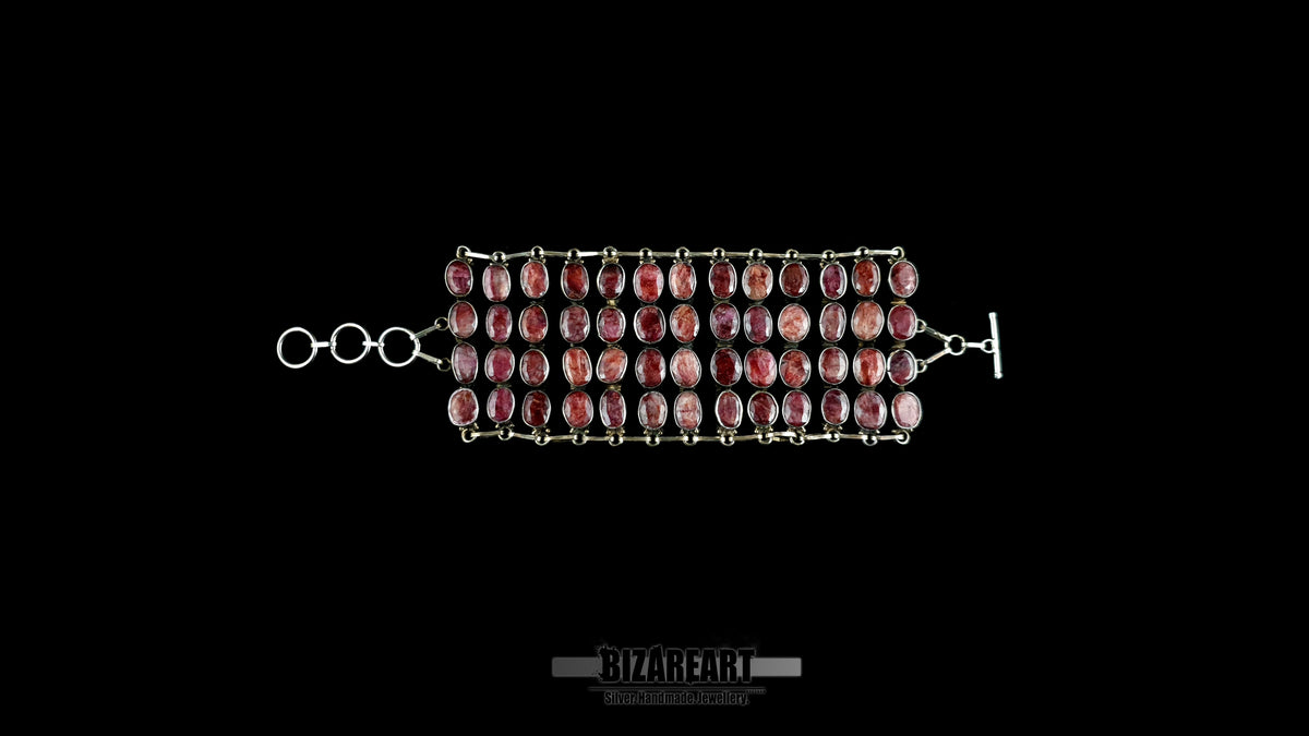 Flat lay view of 140g sterling silver ruby collar fully unrolled showing 3-ring extension chain and custom toggle closure.
