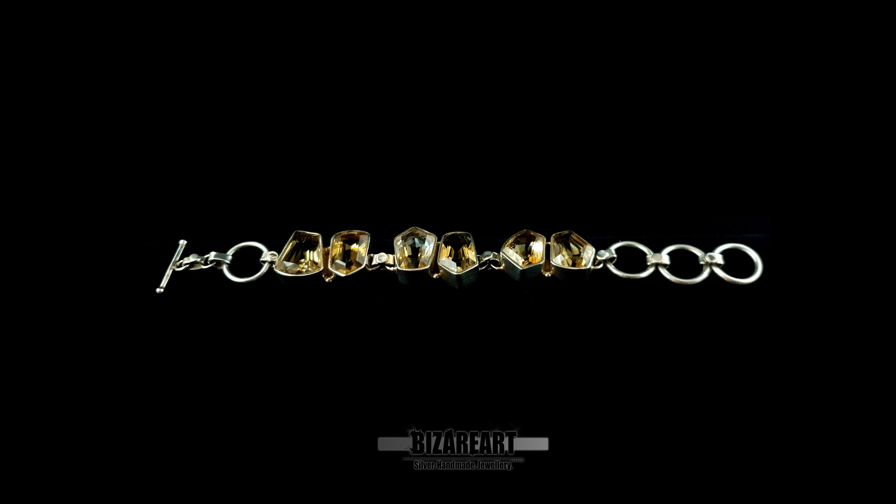 Side profile view showing thick silver bezel walls and freeform citrine crystal facets