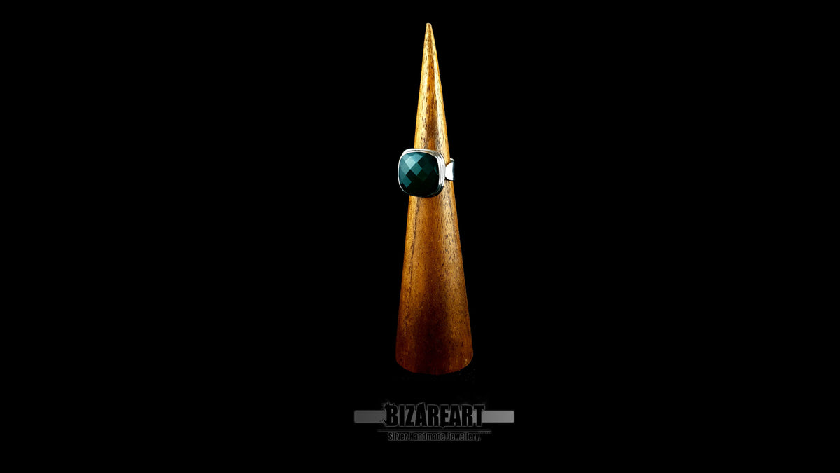 Artisan green onyx statement ring mounted on a wooden display cone