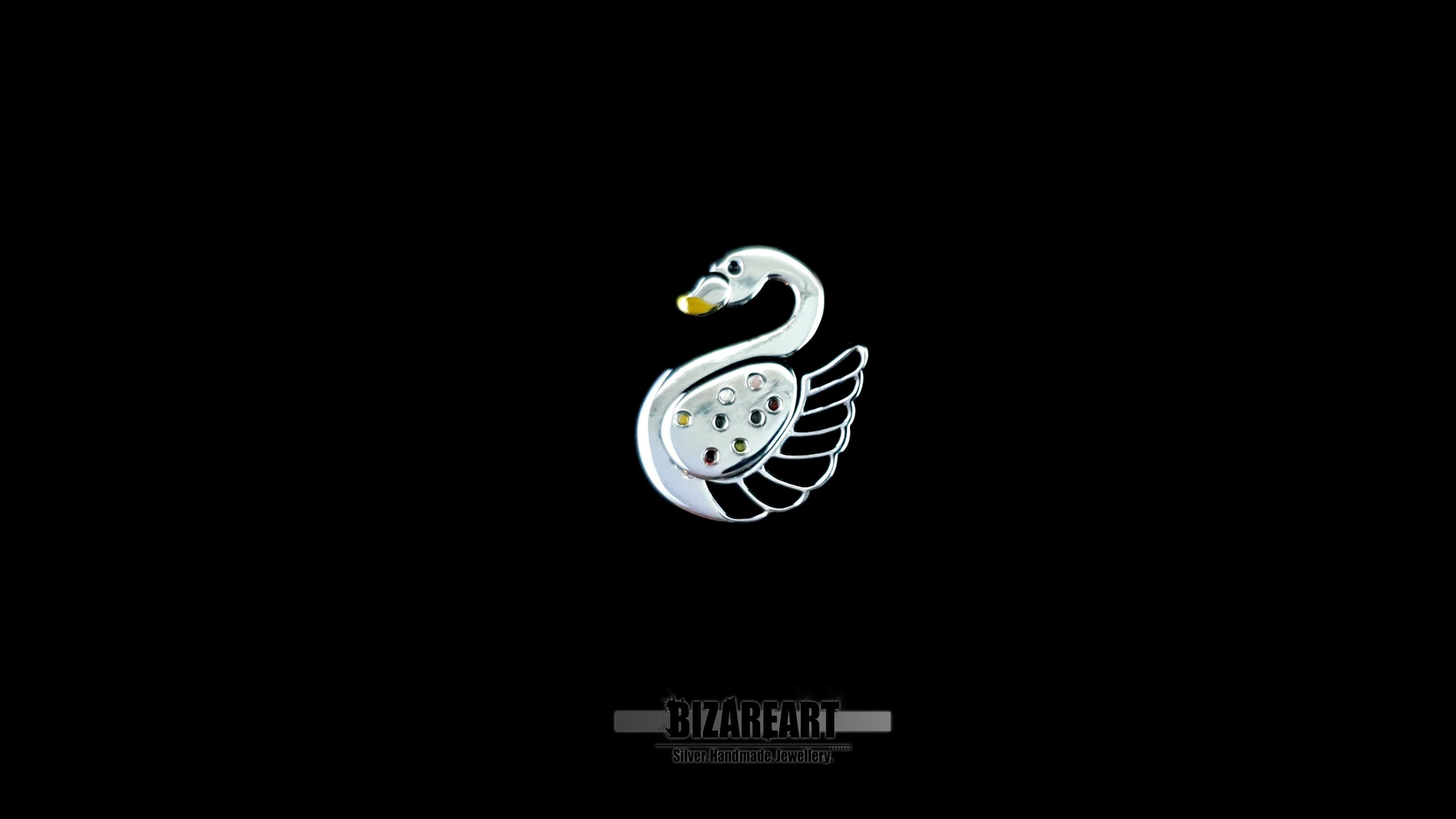 Centered view of a sculptural silver swan pendant against a solid black background highlighting its mirror-like rhodium finish.