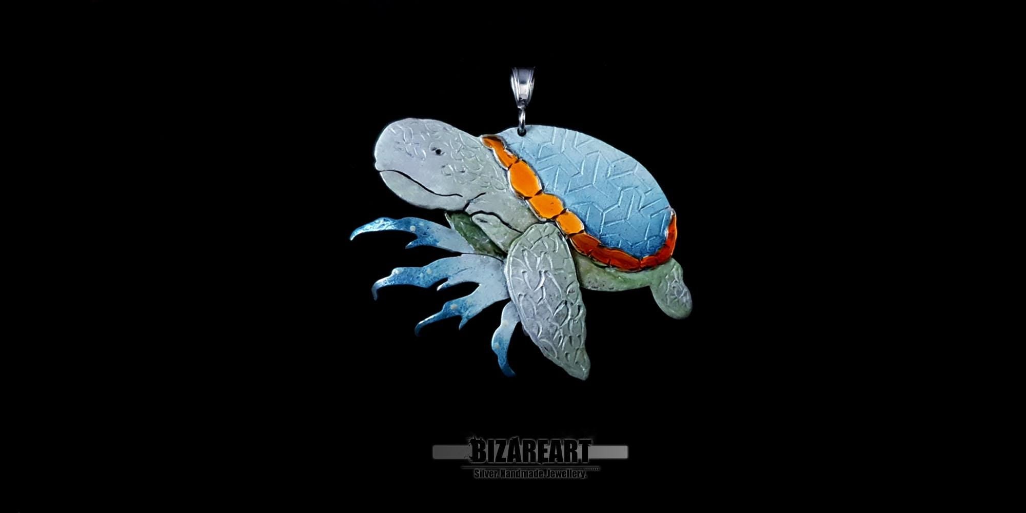 Close-up view of the sea turtle jewelry piece showing the intricate "Tumbling Blocks" engraving on the enamel-coated shell.