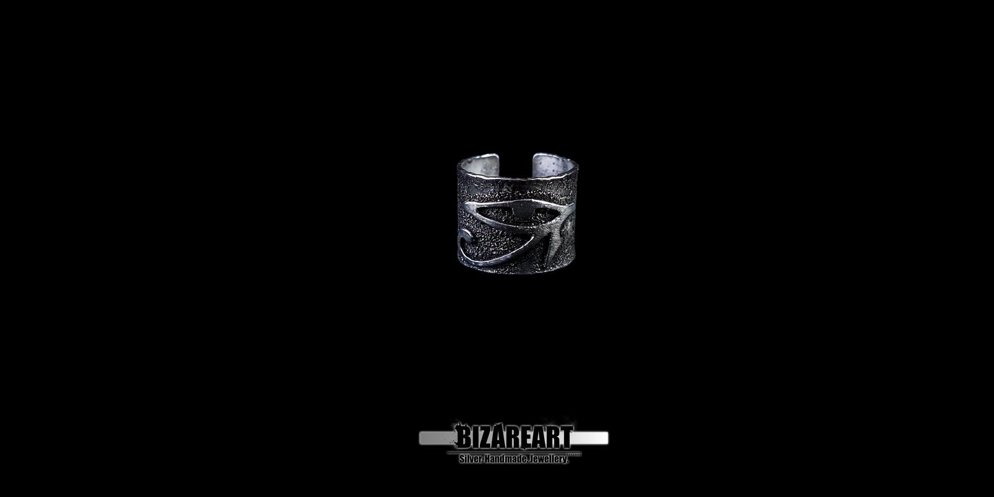 View of the adjustable silver ring band showing the open-back design