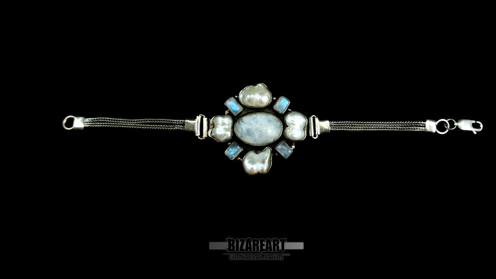 Fully extended 20cm silver artifact bracelet showing the fluid dual-strand chain layout and the structural crab claw clasp against a clean black background.