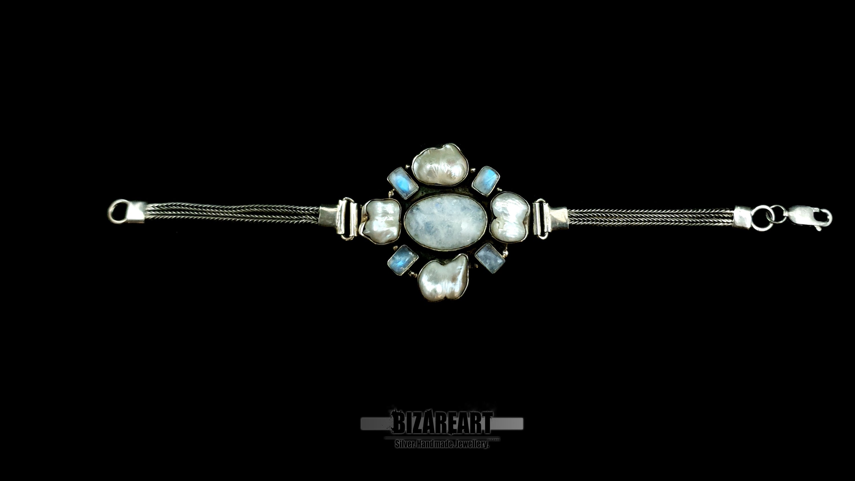 Fully extended 20cm silver artifact bracelet showing the fluid dual-strand chain layout and the structural crab claw clasp against a clean black background.