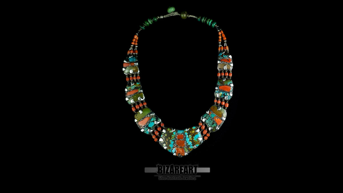 Flat lay of 4 strand turquoise coral silver collar necklace on black background