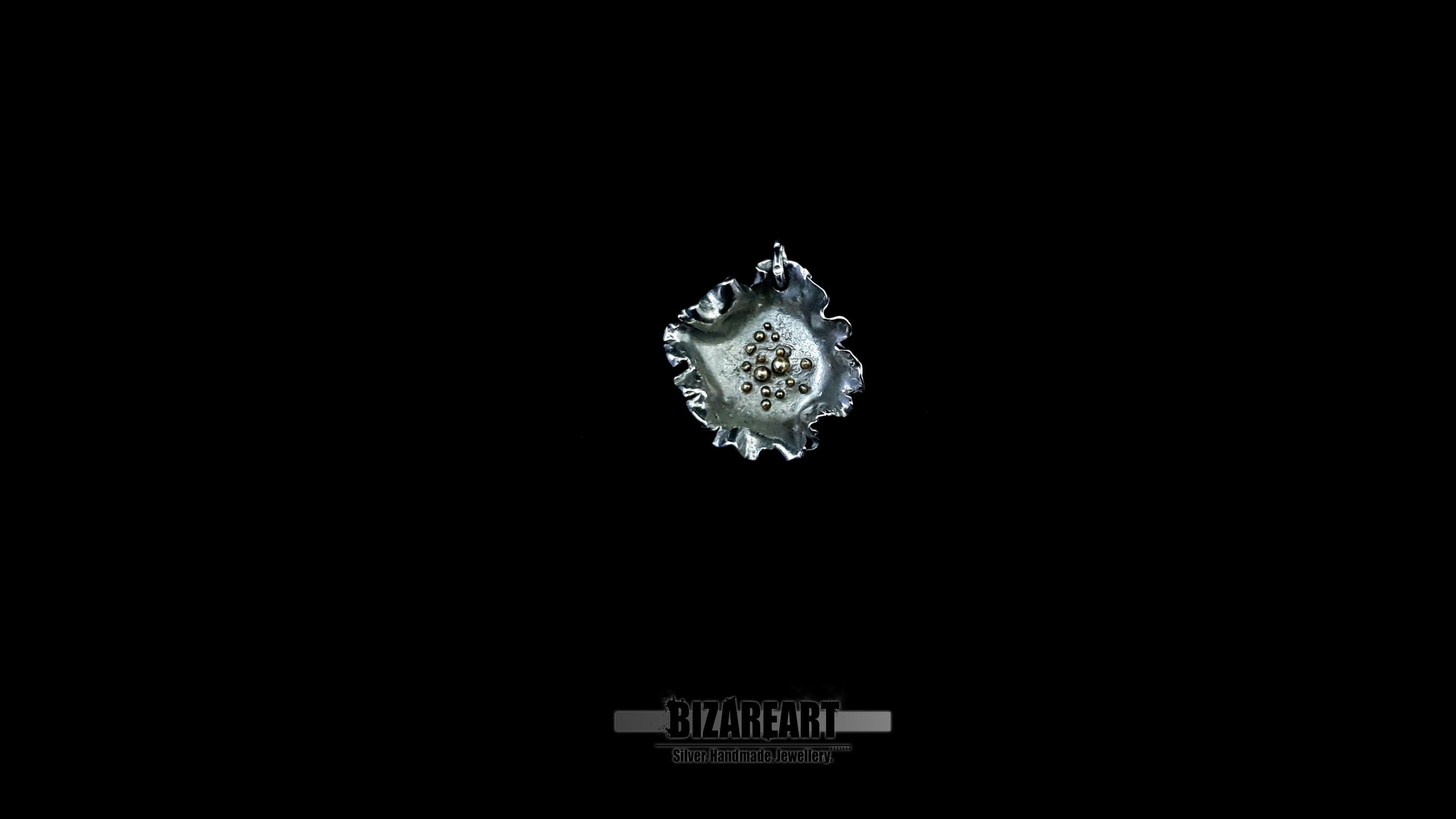 Cinematic product video showcase of a handcrafted silver and gold botanical-style pendant with a signature engraved reverse side.