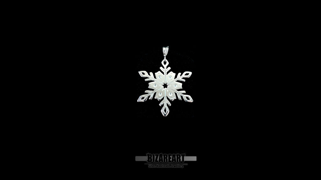 A video showcase of the one-of-a-kind snowflake pendant, rotating to catch the light and demonstrate the "wet look" shimmer of the liquid enamel detailing.